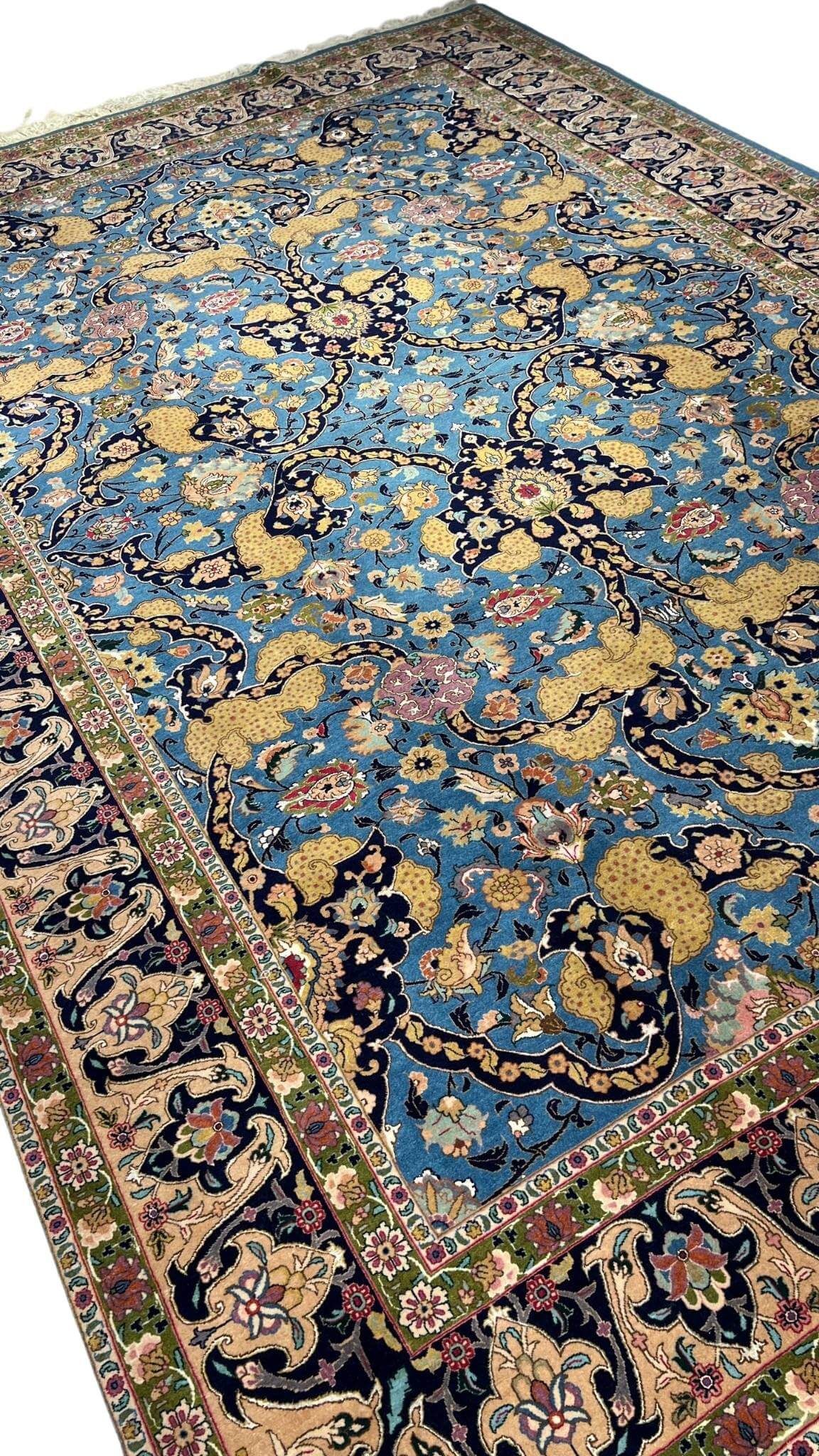 Handwoven Tabriz rug in blue, gold, and pink with natural dyes